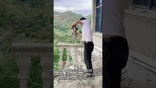 Construction worker dismantling concrete handrails balcony with handle electric tool