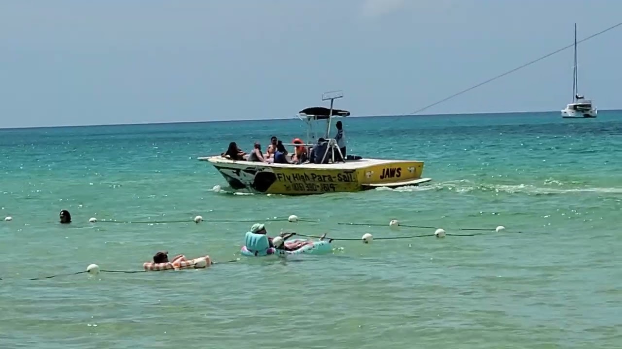 People Par sailing over the ocean in Jamaica. 