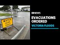 Farmer rescued, evacuation orders issued as rains prompt flood warnings in Victoria | ABC News