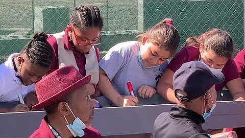 School children sign Charles and Anna Booker beam