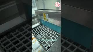 Plates A Dishwashing Machine In A Cafeteria