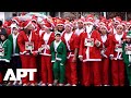 Thousands of Santas Fill Madrid Streets for Annual Red Cross Christmas Charity Run | APT