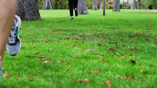 people jogging in the park in trainers slow motion shot at 240fps steadycam