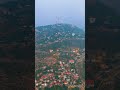 Vertical video. Alanya, Turkey. Aerial view of mountain slope with Alanya Fortress emerging throu...
