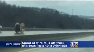 Runaway Giant roll of wire falls from truck, rolls down highway