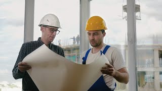 Workers Discussing Blueprints Stock Video