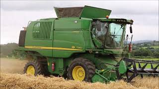 Two John Deere T560 combines cutting barley
