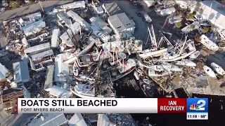 How will the stranded shrimp boats on Fort Myers Beach be cleaned up?