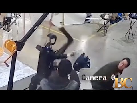 Haunting moment robot attacks handlers in angry rampage as it tries to break free from restraints