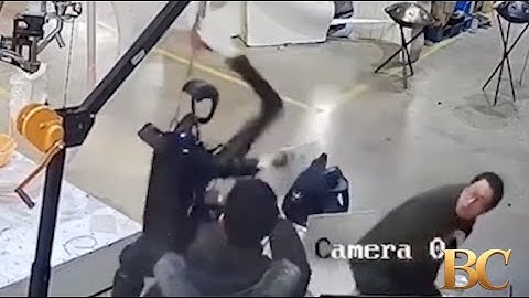 Haunting moment robot attacks handlers in angry rampage as it tries to break free from restraints