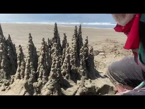 Wave wiping out a sandcastle