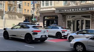 WAYMO X 3. May 31, 2024. Three on Geary. Two continue uphill but  one makes a right turn on Taylor.