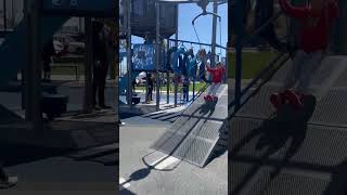 Boy rides on zipline swing then accidentally crashes into little girl standing in the landing zone