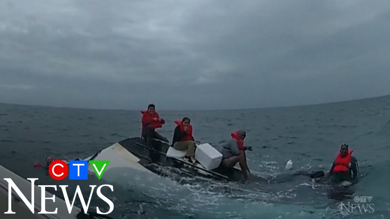 Caught on cam: Boaters rescued after their boat capsizes - YouTube