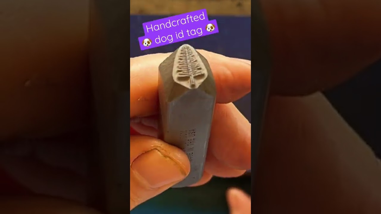 Hand-stamping a dog Id tag - arrow head pet tag with longhorn design