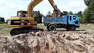 Excavator CAT 312 Rega, Caterpillar E120B in the countryside