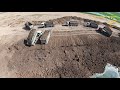 Dump Truck And Bulldozer In Action Building Ground / View Drone FPV