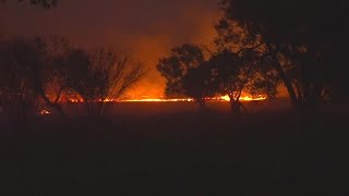 Fire crews working to contain large brush fire near oil business
