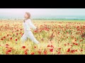 Young beautiful happy girl, dressed in white clothes, runs across the field