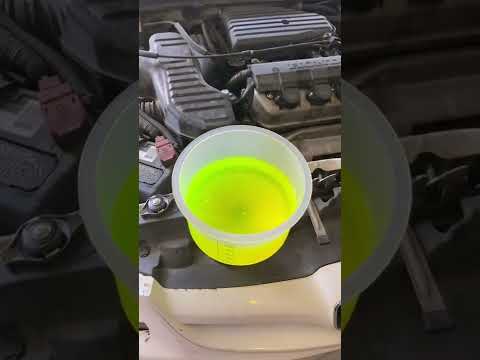 Using a spillproof funnel kit to bleed air out of the radiator.