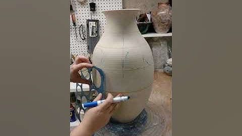 Time lapse of carving and slip trailing a wheelthrown pot