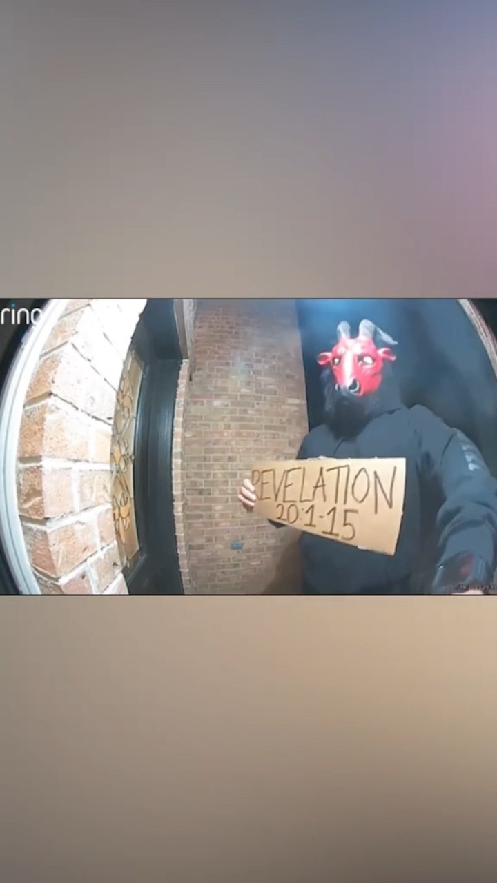 Doorbell camera captures man wearing disturbing mask while holding up Bible verse #shorts