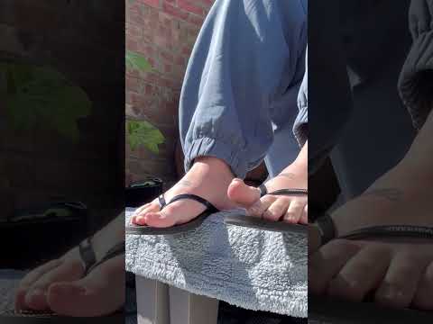 Wiggling toes in black flip flops