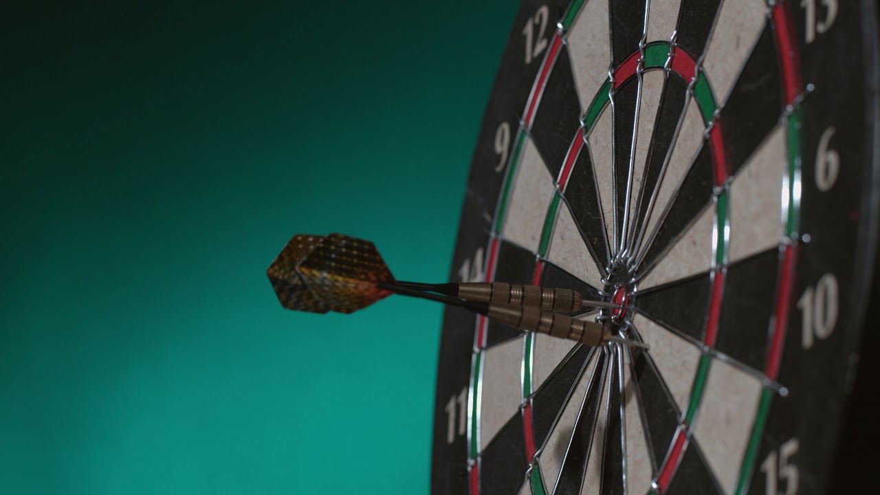 2 shots of Darts hitting board in slow motion