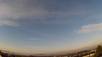 Rolling mist and plane contrails - timelapse