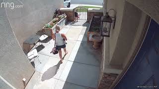 Little girl walks with her head down and bumps into gate in front of house (Security camera)