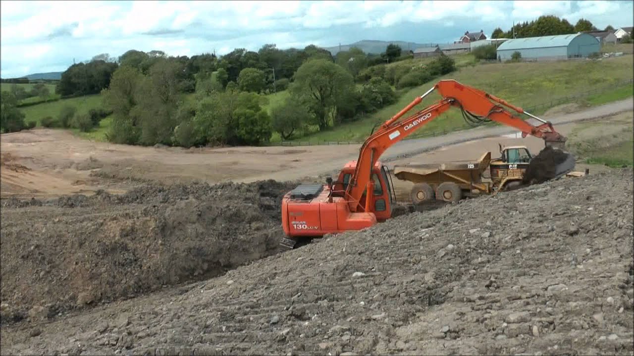 Timelapse / stop motion of excavator loading two dumptrucks