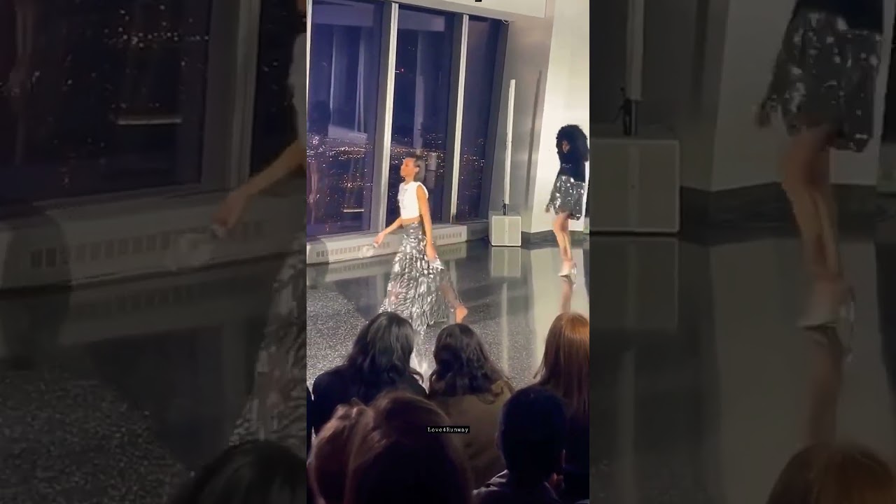 A model taking off her shoes at the Christian cowan fall 2022 