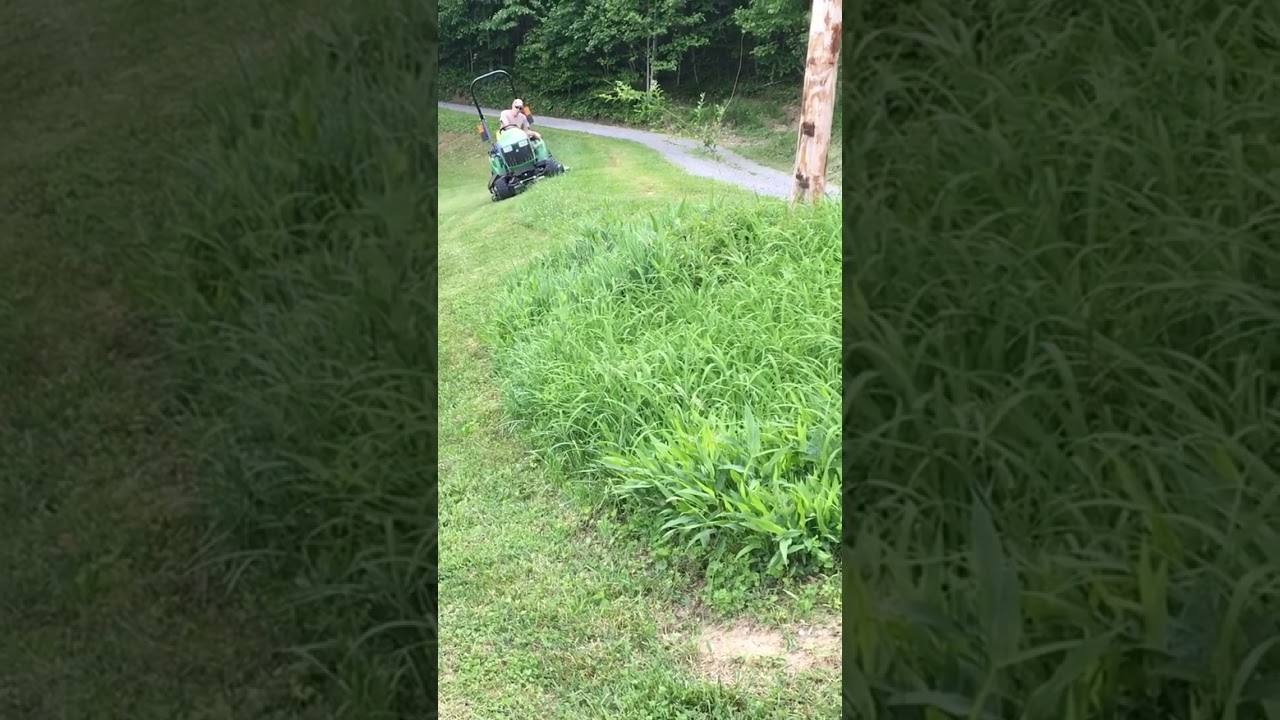 John Deere 1023E Mowing Steep Incline pt.1