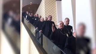 Nine Minutes Of Bishops Coming Down Escalator In High Speed