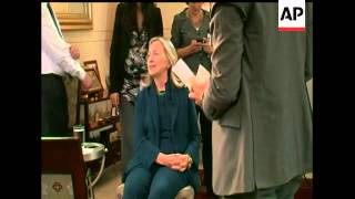 Secretary of State Hillary Clinton exclaimed, "wow," as she read a report on her phone that Moammar