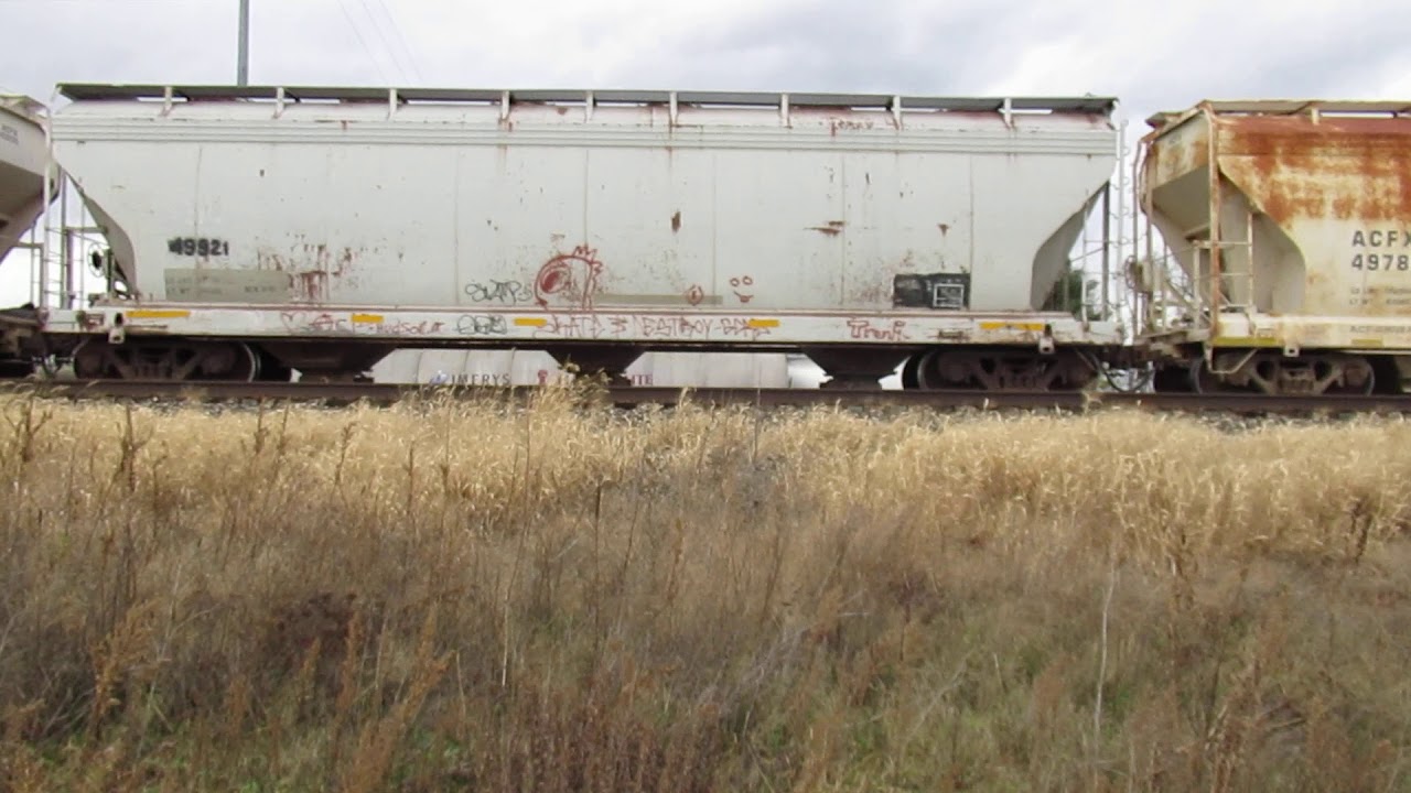 CN 5423, 8878 pushing 6 ACFX ACF Center Flow covered hoppers on the GTW ...
