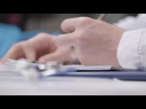 Pull Focus Shot from Stethoscope to Medical Professional Writing