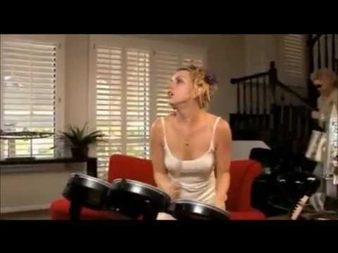 Lexi Belle plays Guns 'N' Roses' Sweet Child O' Mine on Rock Band drums.