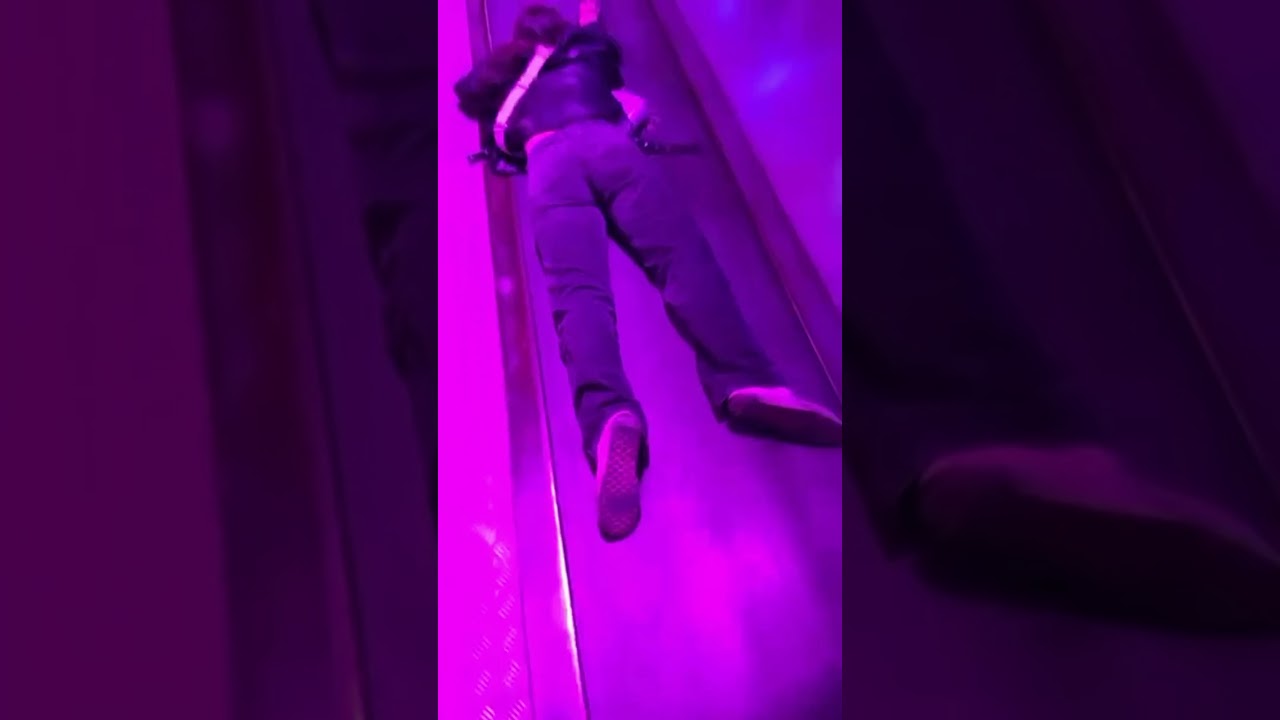 Girl Falling on Conveyor Belt in Amusement Park Ride
