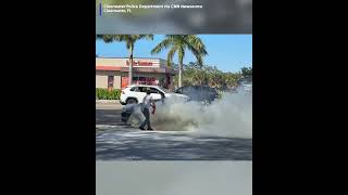 Good Samaritans quickly work together to rescue a man trapped in a car after it erupted into flames