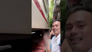 Guy Posing With His Drink As Train Passes Next To Him