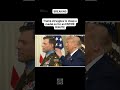 Trump struggles to clasp a medal on for an ENTIRE MINUTE
