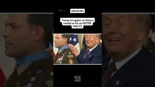 Trump struggles to clasp a medal on for an ENTIRE MINUTE