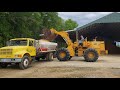 Spreading sawdust in our chicken houses after cleanout