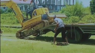 The process of lifting and lowering a mini excavator from a mini self loader is as follows: