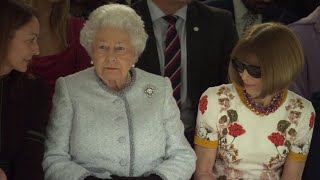 Queen Elizabeth II Takes in Fashion Show with Anna Wintour