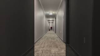 Guy pushes his little boy in wagon down hotel hallway then boy crashes into wall and bumps head