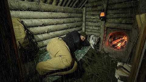 Building an underground shelter, a dugout for survival in the wild. Fireplace. Cooking over a fire.