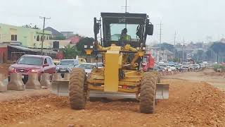 Caterpillar Grader pushing gravel material like Dozer