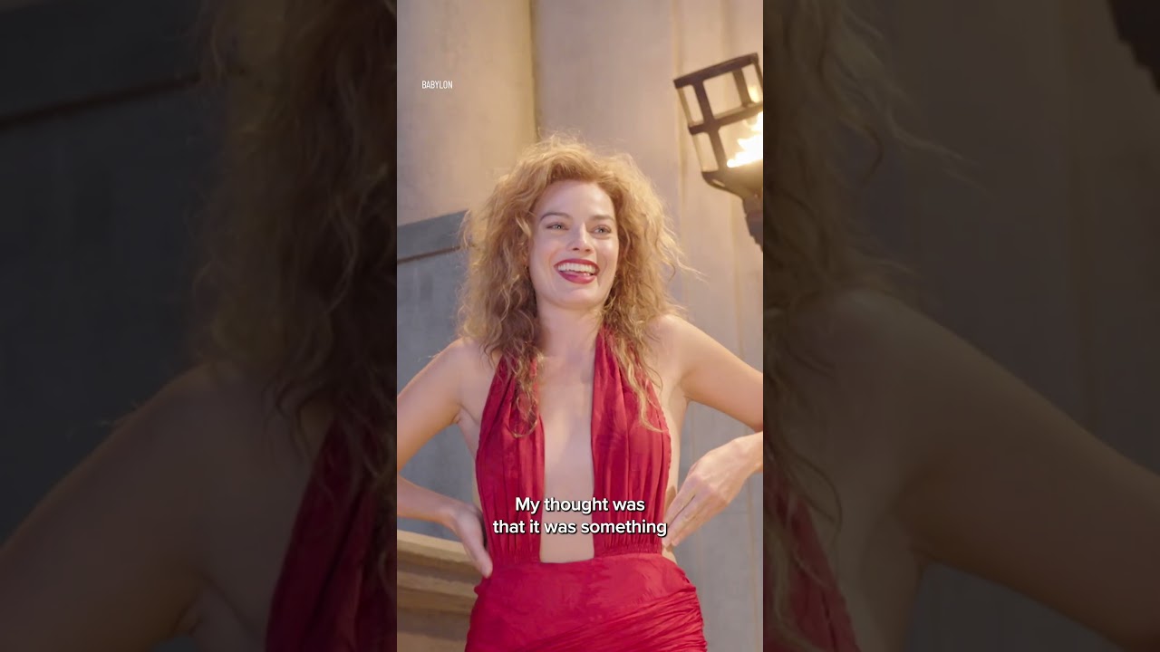 nellie laroy red dress Margot Robbie Nods To Her 'Babylon' Costume In Caped Valentino